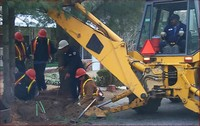Workers Overlooking Machine Digging